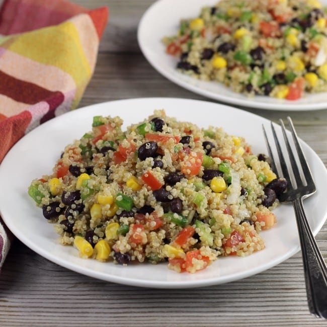 A side angle view of a couple of plates with quinoa salad.