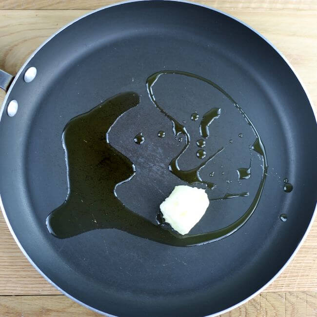 Butter and oil are added to a large skillet.