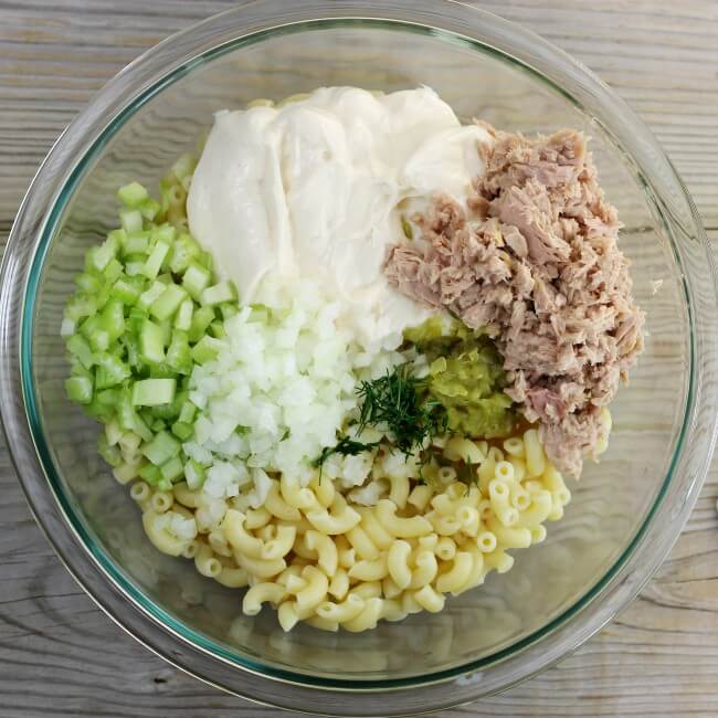 Celery, onion, tuna, dill, pickle relish, and macaroni in a large bowl.