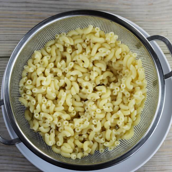 Noodles draining in a colander.