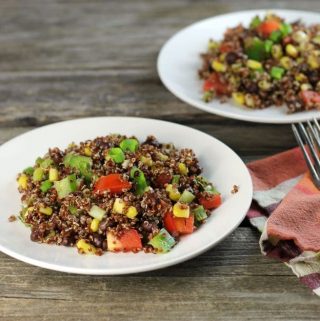 Black bean quinoa salad a hearty and healthy salad filled with chopped tomatoes, green pepper, and green onions.