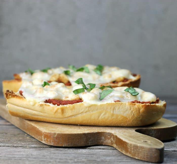 Chicken Parmesan French Bread Pizza a simple delicious pizza ready in under 30 minutes that combines chicken parmesan and pizza all into one.