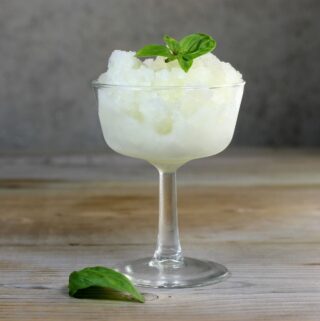 Looking at a side view of a dessert cup with a frozen lemon dessert.