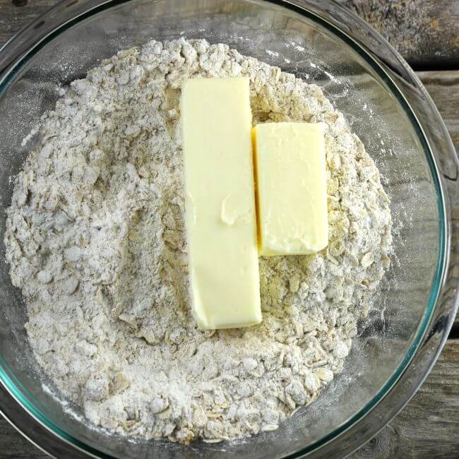 The butter is added to the flour and oats mixture.