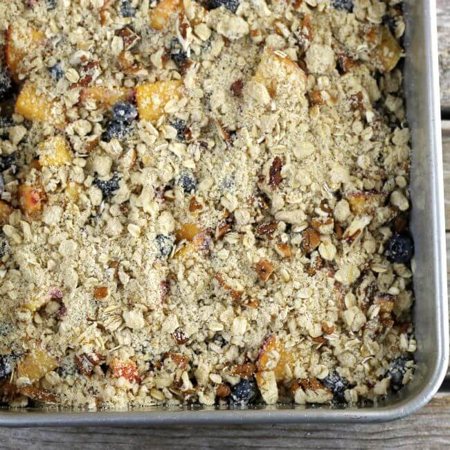 Unbaked blueberry peach bars in a baking pan.