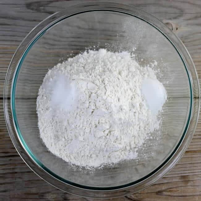 Flour, baking powder, and salt are added to a small mixing bowl.