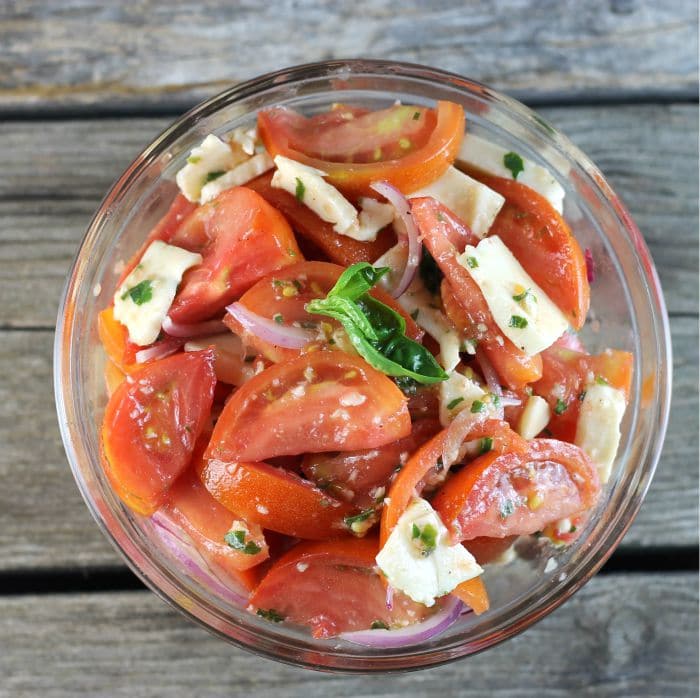 Tomato Mozzarella Salad made with tomatoes, mozzarella, and tossed with a vinaigrette dressing makes for a perfect end of the summer side dish.