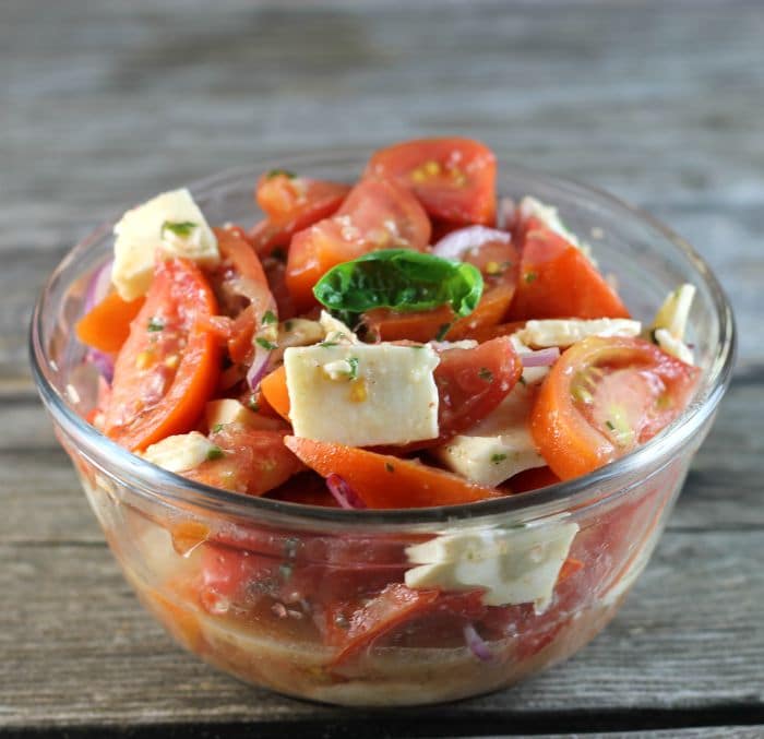 Tomato Mozzarella Salad made with tomatoes, mozzarella, and tossed with a vinaigrette dressing makes for a perfect end of the summer side dish.