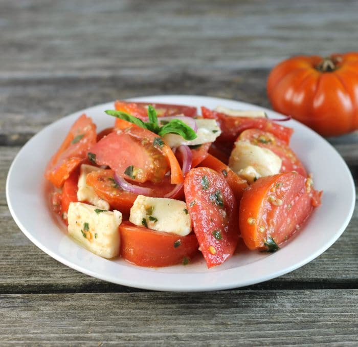 Tomato Mozzarella Salad made with tomatoes, mozzarella, and tossed with a vinaigrette dressing makes for a perfect end of the summer side dish.