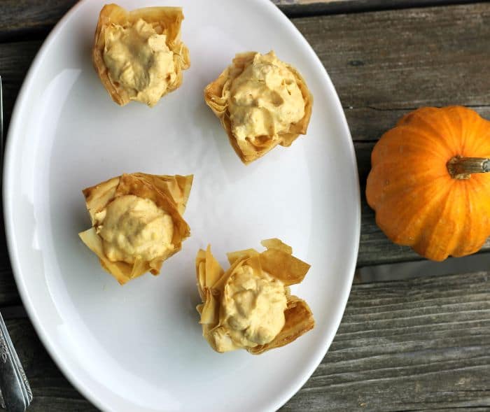 Mini Pumpkin Pie Tarts have a crispy phyllo shell and a no-bake pumpkin cream cheese filling perfect for the holiday season.