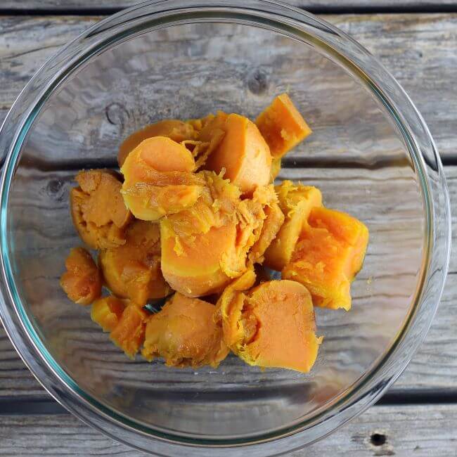 Roasted sweet potatoes added to a mixing bowl.