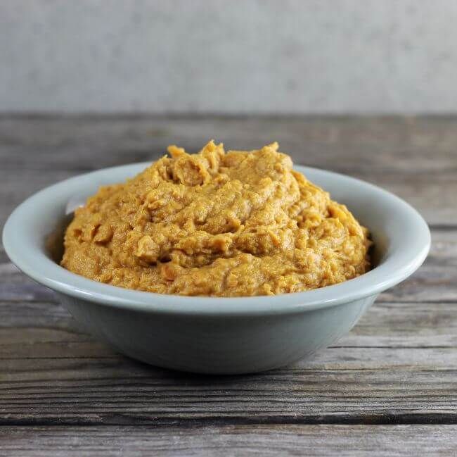 Side view of a bowl of mashed sweet potatoes.