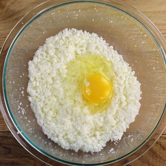 An egg is added to batter.