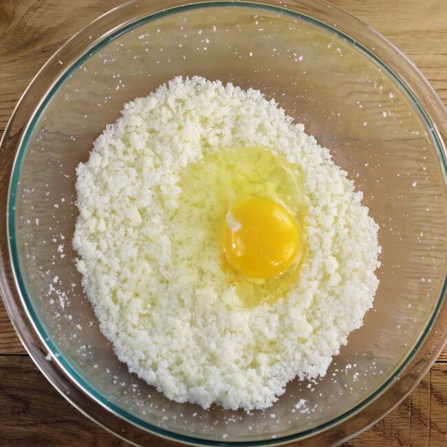 An egg is added to batter.