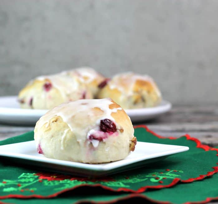 Cranberry orange pecan buns soft buns filled with cranberry, pecans, and hint of orange then topped with an orange icing; perfect for Christmas morning.