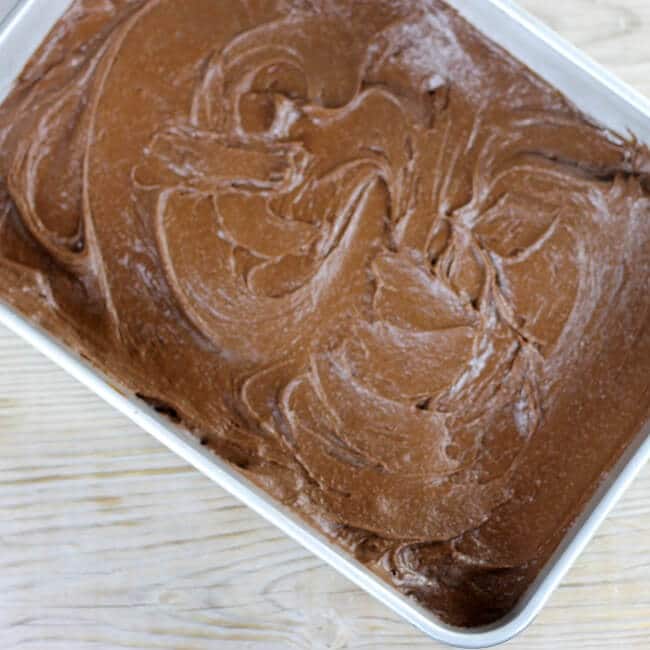The brownie batter is spread in the baking pan.