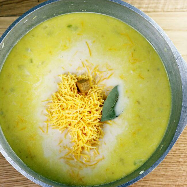 Cheese and bay leaf are added to the soup.