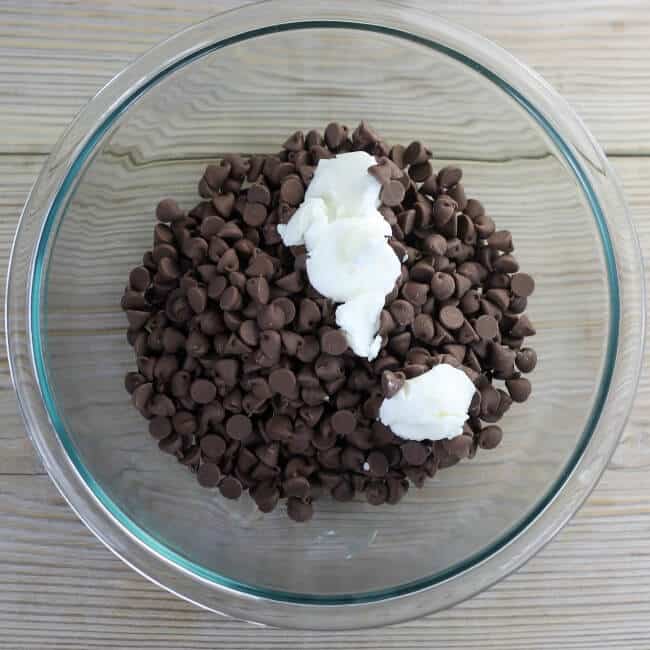 Chocolate chips and shortening in a mixing bowl.