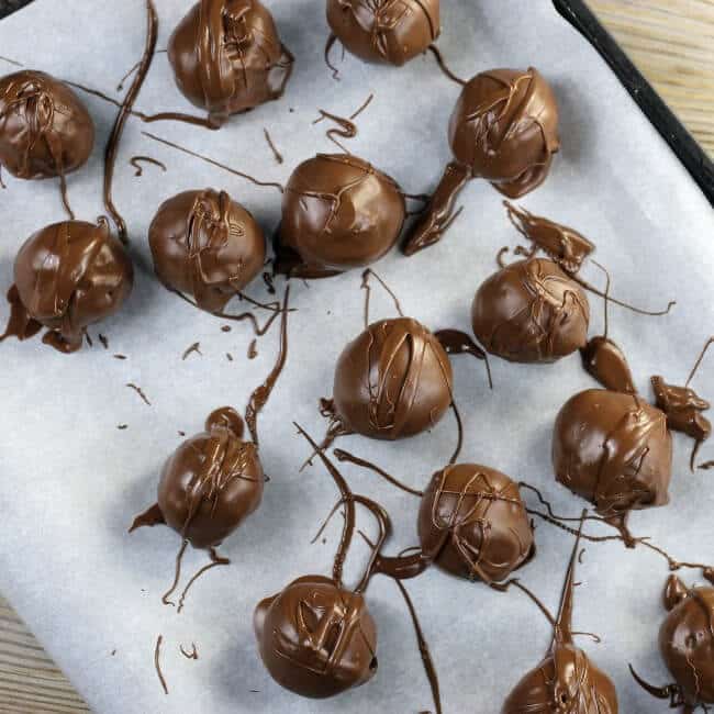 Truffles are place on a baking sheet lined with parchment paper. 