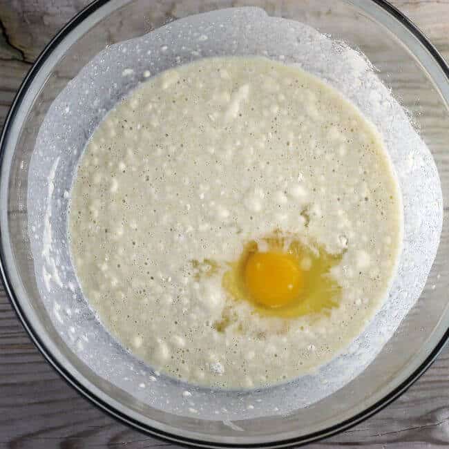 An egg is added to the bread dough batter.