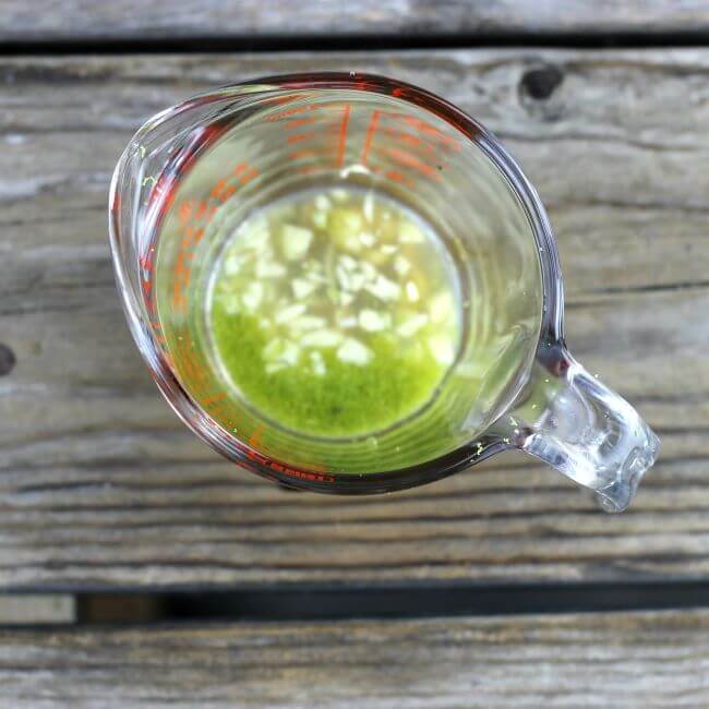 Lime juice, Lime zest, honey, and garlic in a measuring cup.