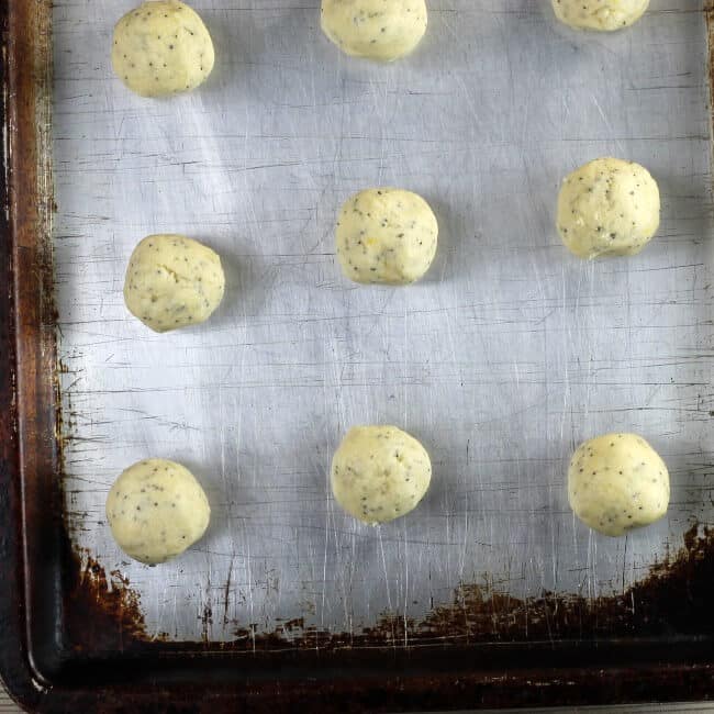 Cookie dough rolled into balls and placed on a baking sheet.