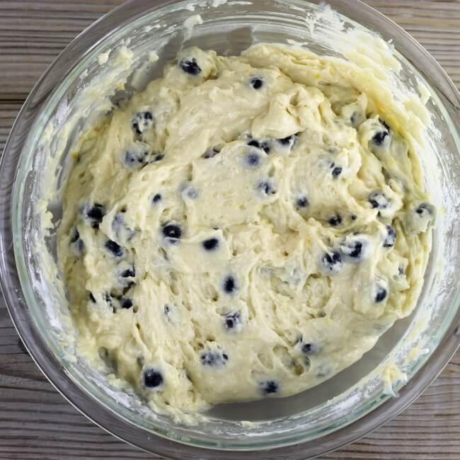 Blueberry muffins batter in a glass bowl.