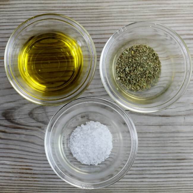 Olive oil, seasoning, and salt in bowls.