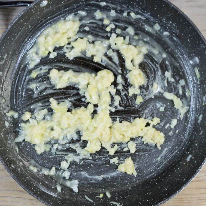 Flour and onion mixture in a large black skillet.