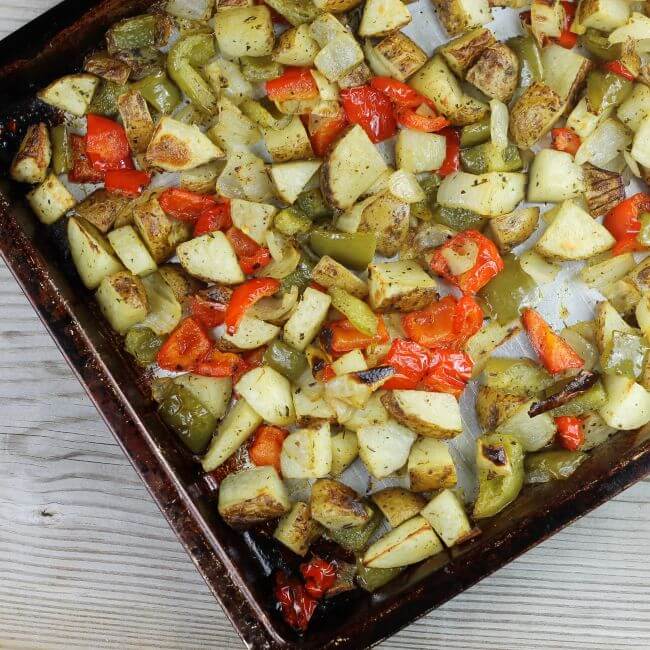 Looking down at roasted vegetable in a sheet pan.