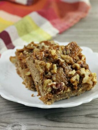 Side view of caramel apple spice bars are stacked on a plate.