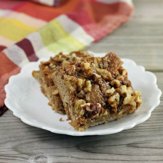 Side view of caramel apple spice bars are stacked on a plate.