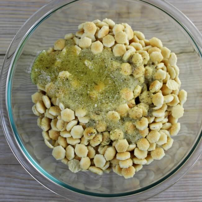 The olive oil mixture is poured over the crackers.