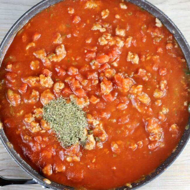 Seasoning is added to the skillet. 