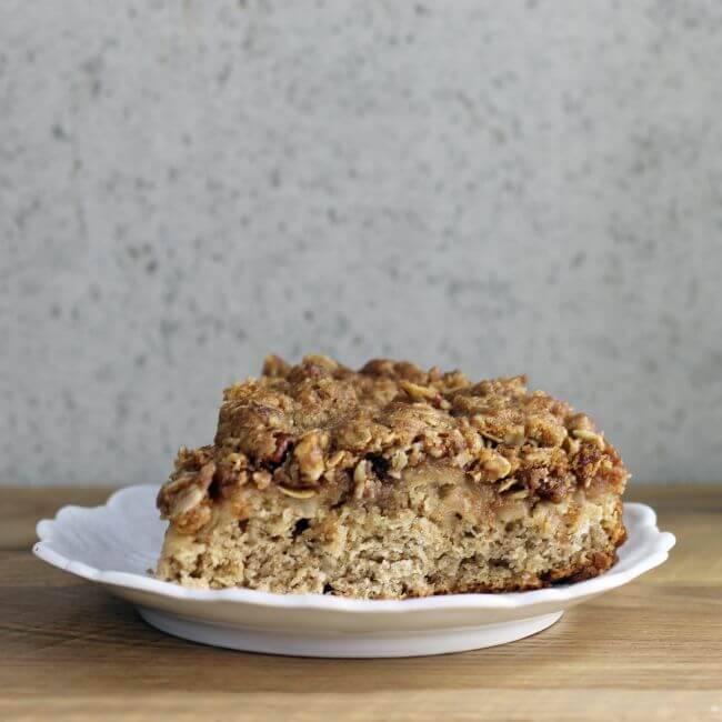 A side view of a slice of apple coffee cake.