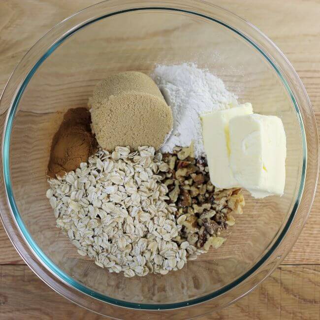 The crumble ingredients are put into a glass bowl.
