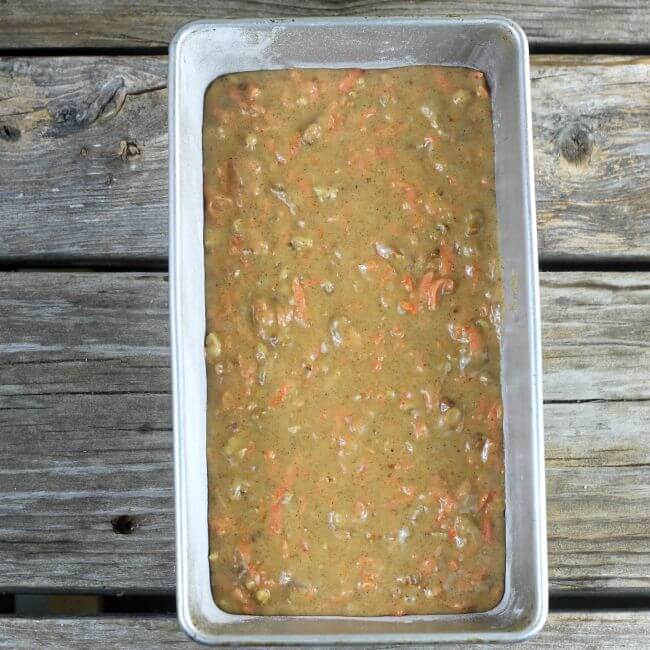 Unbaked carrot quick bread in a loaf pan.