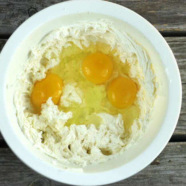 cream cheese and eggs in a whitle bowl