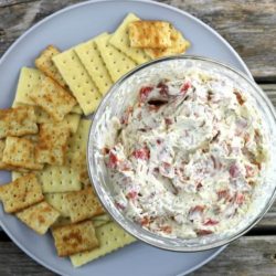 Pepperoni Dip on a gray plate with crackers.