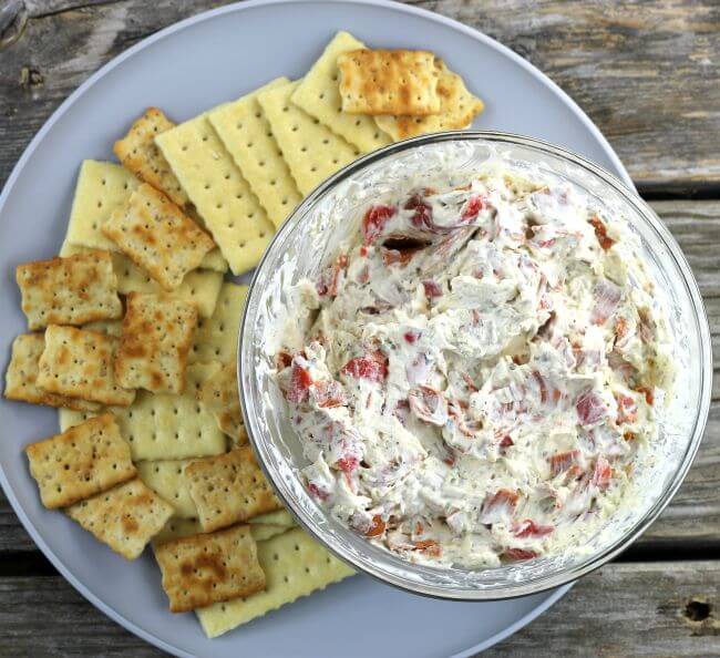 Pepperoni Dip on a gray plate with crackers.