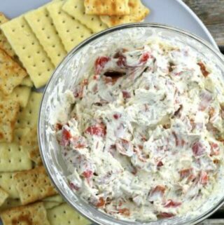 Pepperoni Dip on a gray plate with crackers.