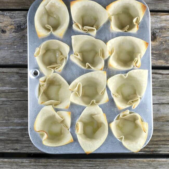Baked wonton wrappers in a mini muffin tin.