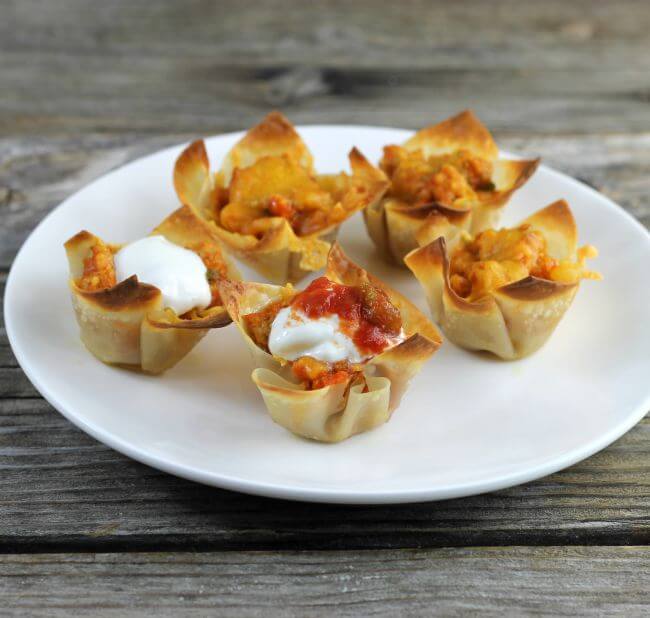 Wonton taco cups on a white plate.