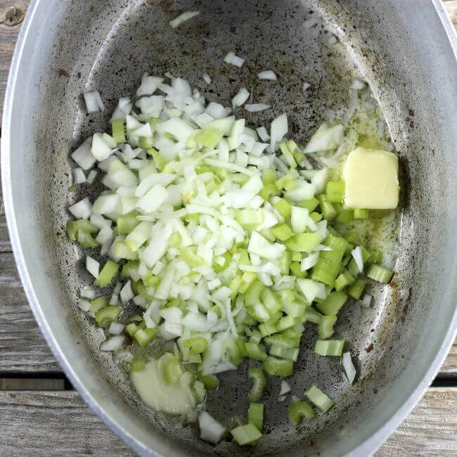 Onions, celery, and butter in a Dutch oven kettle.