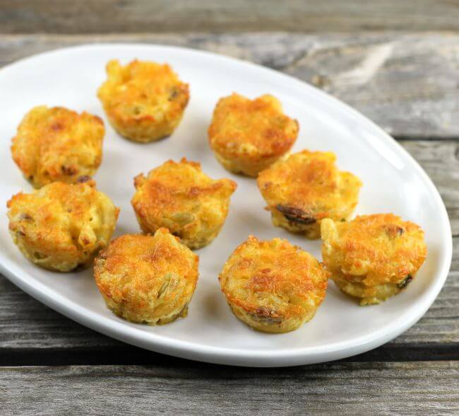 Macaroni and cheese bites on a white platter.