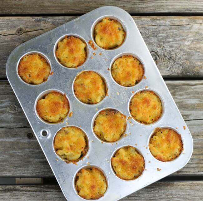 Macaroni and cheese bites in a mini muffin tin.