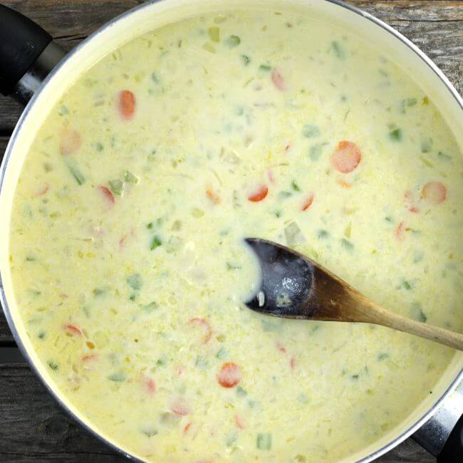 White sauce with vegetables for the tater tot chicken pot pie casserole.