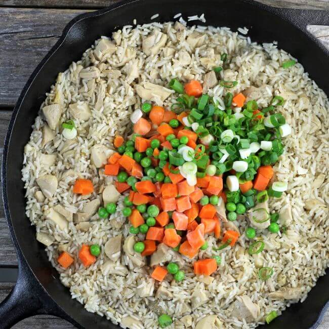 Add the veggetables in the skillet with the fried rice.