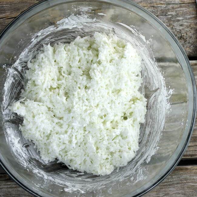 Coconut is mixed into the beaten egg whites.