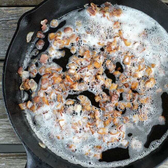 Bacon frying in a skillet.